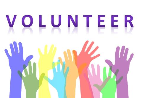 The word volunteer with upstretched hands in all colors