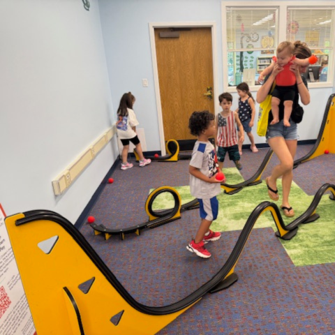 Children playing with build your own roller coaster from Westchester Children's Museum