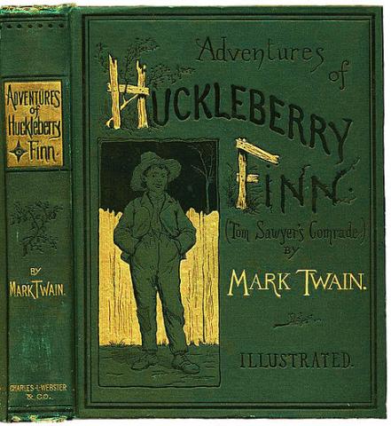 The title "The Adventures of Huckleberry Finn" followed by the name Mark Twain on a green background. The capital H in Huckleberry and F in Finn are made of stumps and planks. Next to the text is an image of a boy in overalls and a straw hat in front of a wooden fence.
