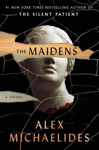 A black background behind the head of a marble statue of a woman. All over the cover are cracks filled with gold. A crack that runs over the eyes of the statue is missing to reveal a hazy mountain range at sunset with the title "The Maidens" written in it. The name Alex Michaelides is written along the bottom.